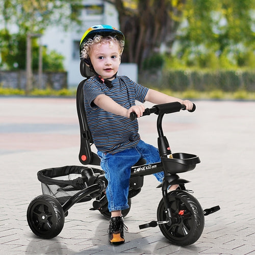 Qaba Baby Tricycle 4 In 1 with adjustable seat, child wearing a helmet, outdoors on a paved surface.